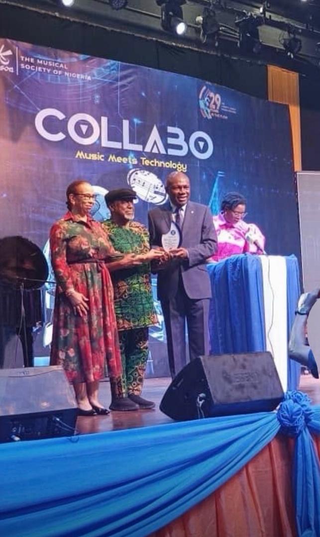 L-R: CEO of GenAI LC, Sonny Iroche, flanked by his wife, Suzanne, being presented with the Award as the Keynote Speaker by Yemi Akisanya Esq at MUSON Centre: Music Meets Technology. October 21, 2025
